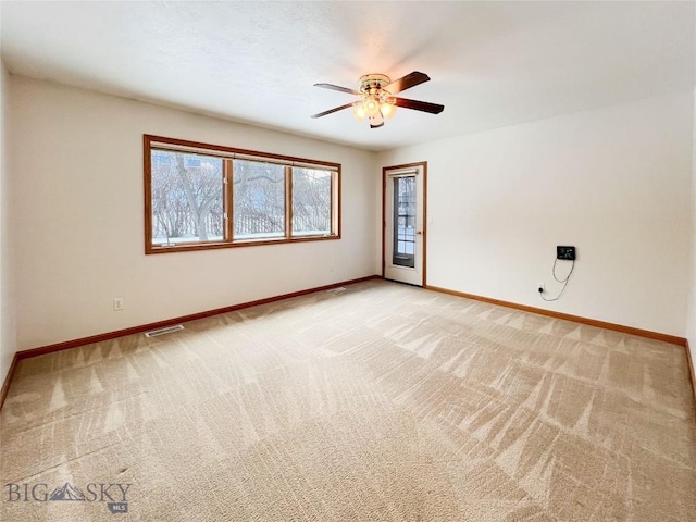 unfurnished room with light carpet, visible vents, a ceiling fan, and baseboards