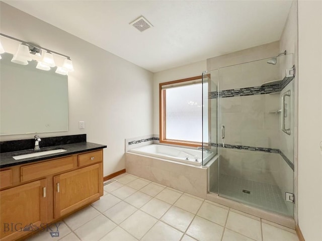 bathroom with tile patterned floors, visible vents, a stall shower, a bath, and vanity