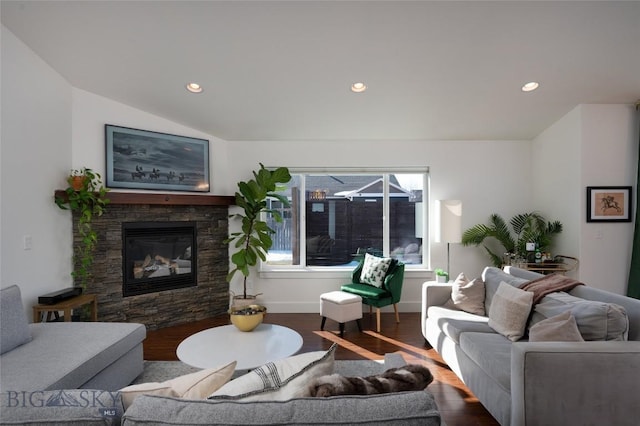 living room featuring dark wood finished floors, a stone fireplace, and recessed lighting