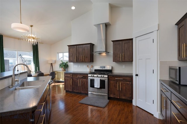 kitchen featuring a sink, stainless steel appliances, dark wood-style floors, and wall chimney exhaust hood