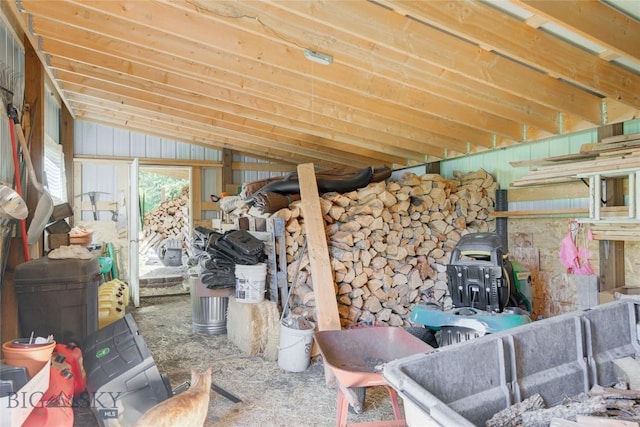 miscellaneous room featuring a wood stove and vaulted ceiling