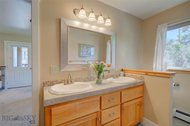 full bath featuring double vanity, a sink, and a baseboard radiator