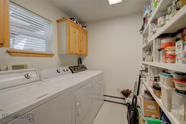 laundry area with washing machine and clothes dryer, baseboard heating, and cabinet space