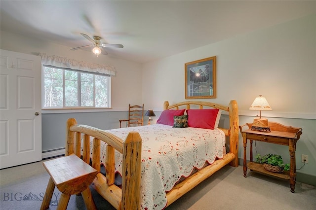 carpeted bedroom featuring a baseboard heating unit and ceiling fan