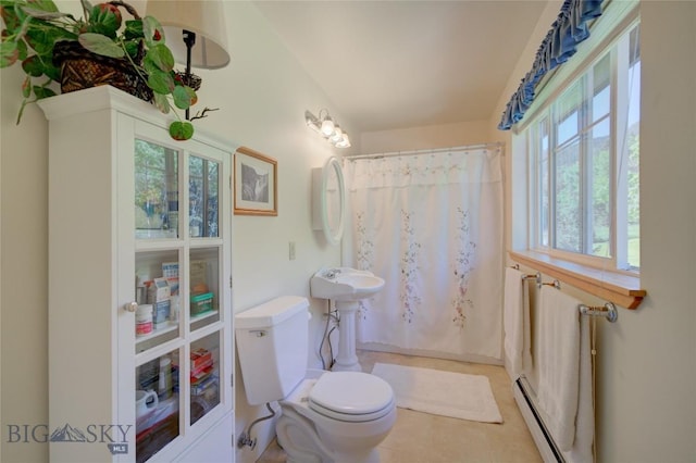 bathroom featuring tile patterned floors, toilet, a shower with shower curtain, and a baseboard radiator