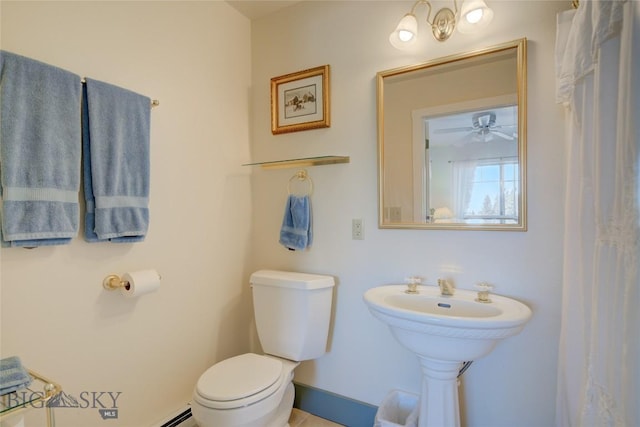 bathroom with toilet and baseboards