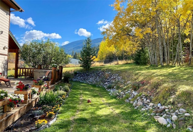 view of yard with a patio area, a mountain view, and fence