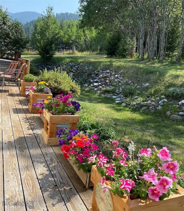 exterior space with a deck with mountain view and a forest view