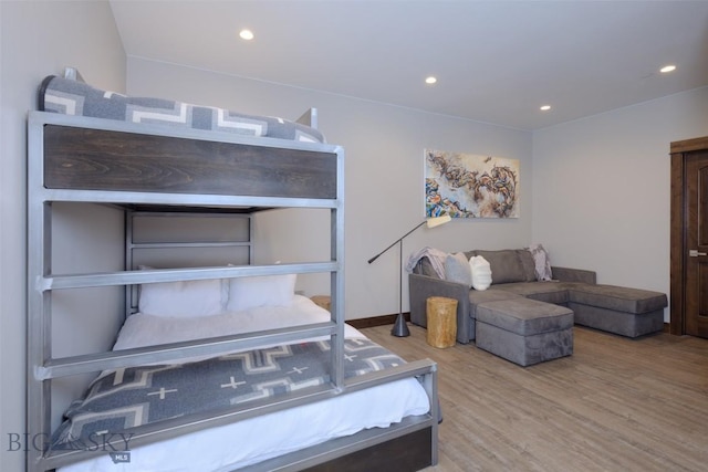 bedroom featuring recessed lighting and wood finished floors