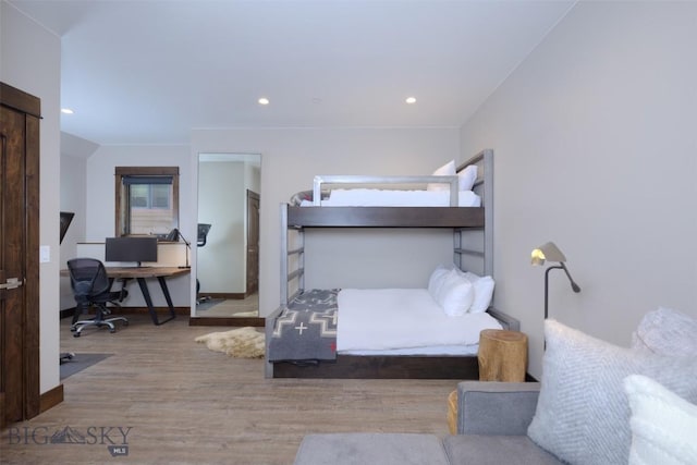 bedroom with recessed lighting, wood finished floors, and baseboards