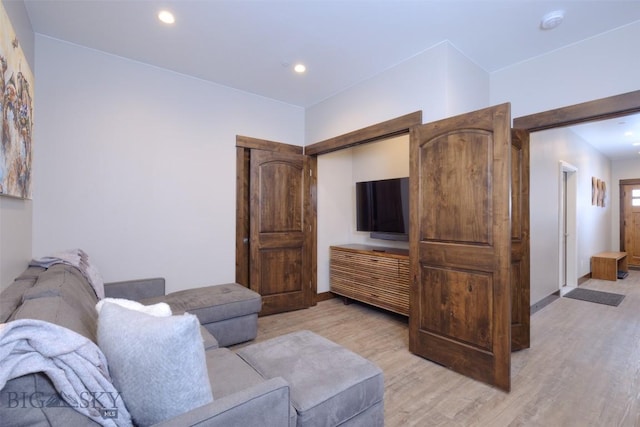 living area with recessed lighting, baseboards, and light wood-style floors