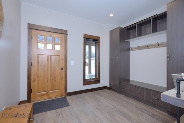 mudroom featuring recessed lighting, light wood-style flooring, and baseboards