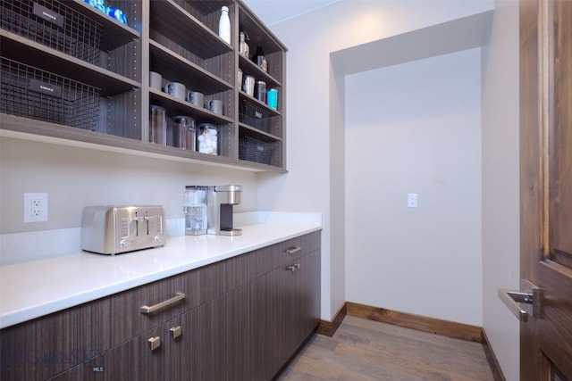 bar featuring baseboards and wood finished floors