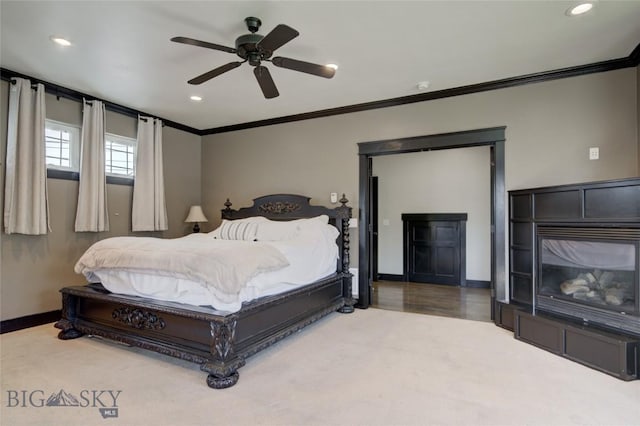 carpeted bedroom with recessed lighting, ceiling fan, baseboards, and ornamental molding