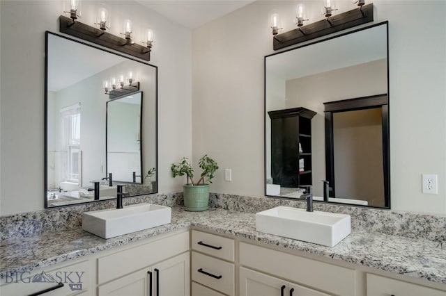 bathroom with a sink and double vanity