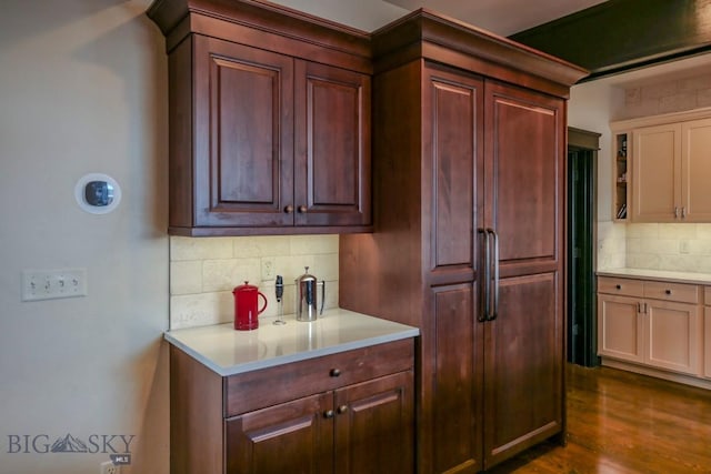 kitchen featuring decorative backsplash, dark wood finished floors, and light countertops