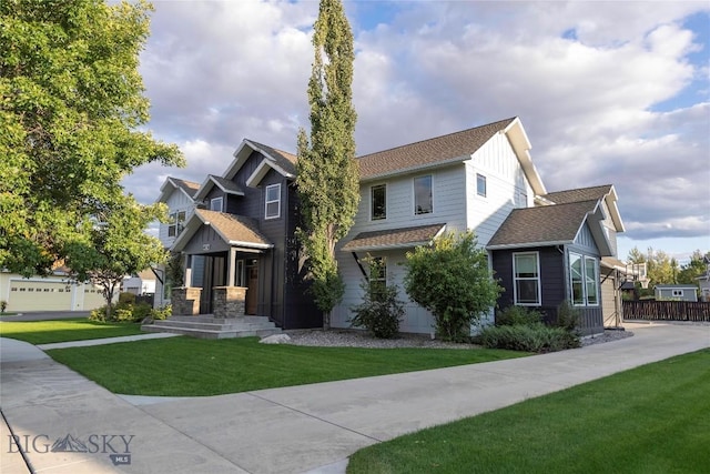 view of front of home featuring a front yard, fence, and board and batten siding