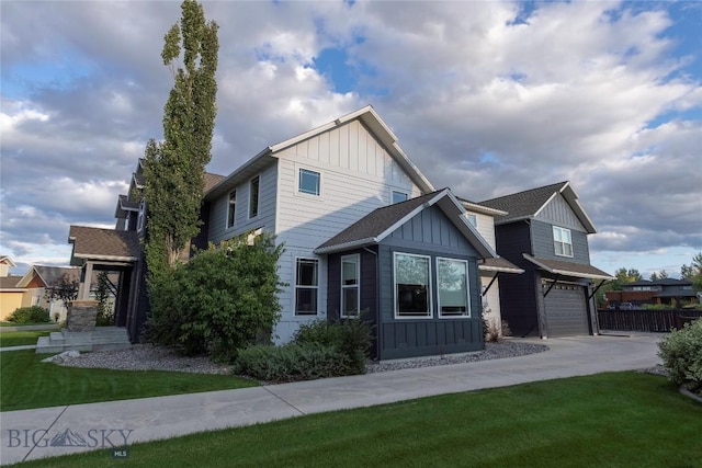 view of front facade featuring board and batten siding, a front lawn, driveway, and a garage