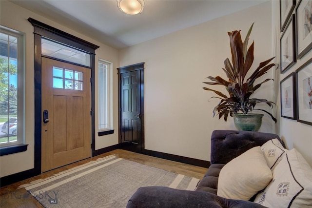 entryway with light wood-style floors and baseboards