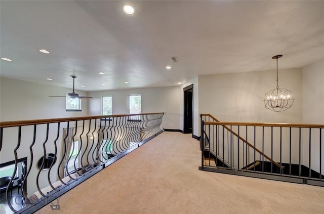 hall with visible vents, light colored carpet, an upstairs landing, recessed lighting, and an inviting chandelier