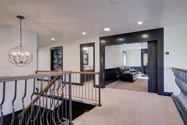 corridor featuring recessed lighting, an upstairs landing, carpet floors, and a chandelier