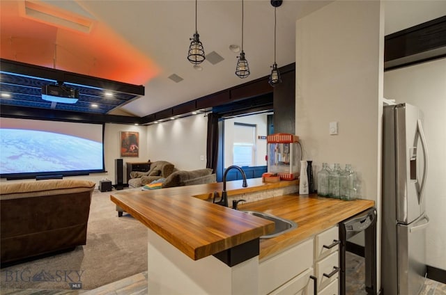 carpeted home theater room featuring a sink