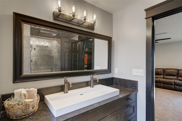 bathroom featuring a shower stall and vanity