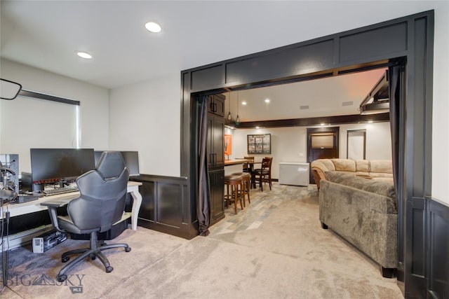 home office with recessed lighting, light colored carpet, wainscoting, and a decorative wall