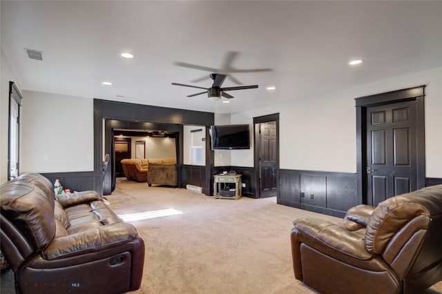 living area with visible vents, light carpet, recessed lighting, wainscoting, and ceiling fan