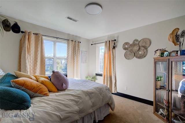 bedroom featuring visible vents, baseboards, and carpet flooring