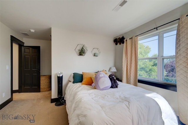 carpeted bedroom featuring visible vents and baseboards