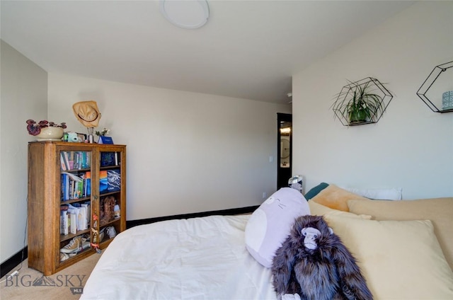 bedroom featuring light colored carpet and baseboards