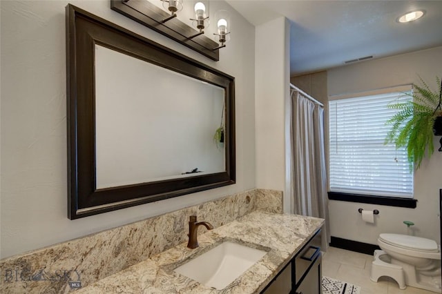 bathroom featuring vanity, visible vents, an inviting chandelier, tile patterned flooring, and toilet