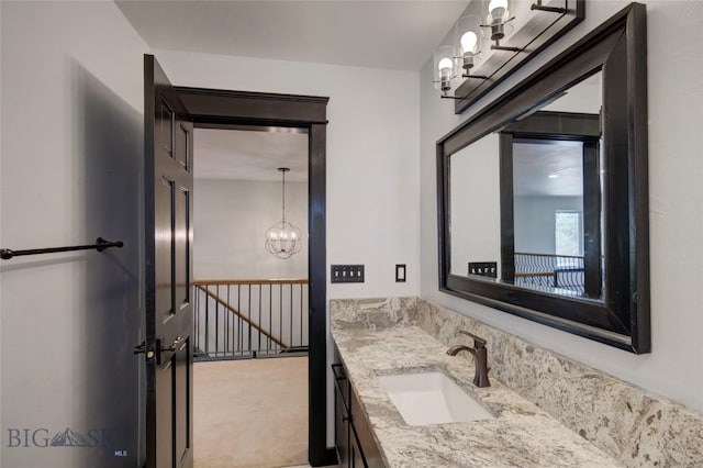 bathroom featuring vanity and a chandelier