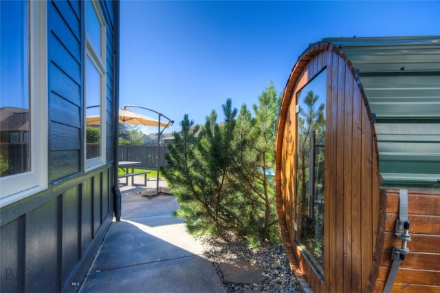 view of gate with a patio area and fence