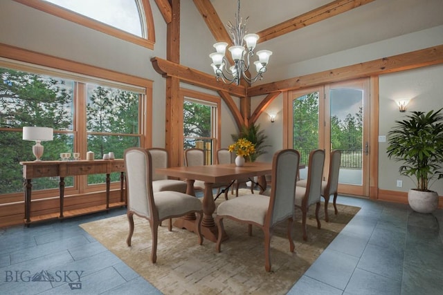 dining space featuring a notable chandelier and a towering ceiling