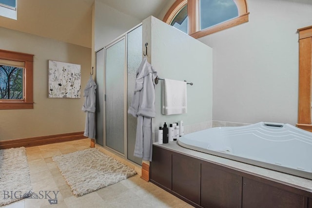 full bath featuring a shower stall, baseboards, and a whirlpool tub