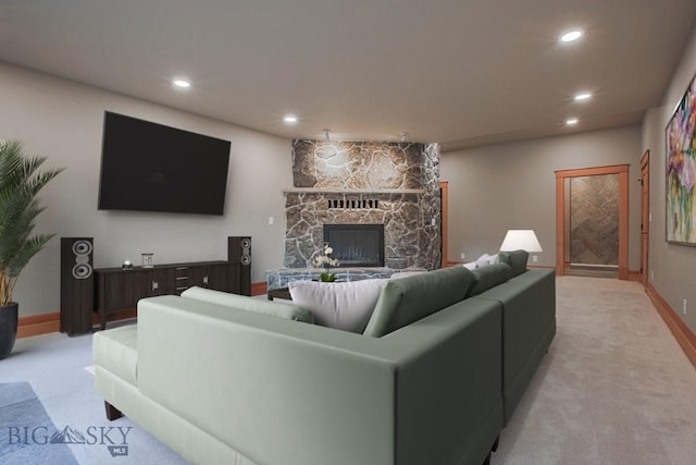 living room featuring recessed lighting, light colored carpet, and a fireplace