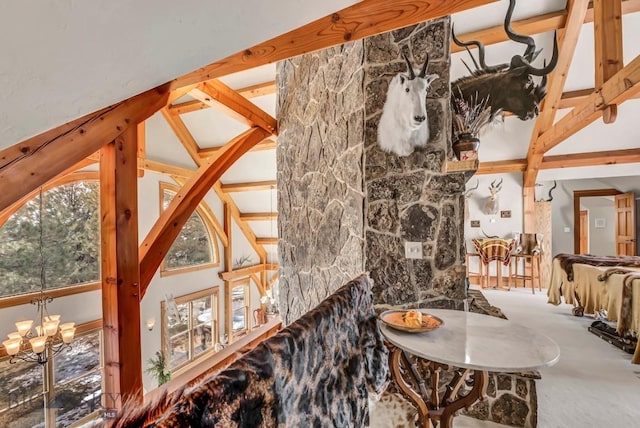 interior space with beam ceiling and a chandelier