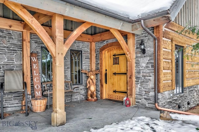 entrance to property featuring stone siding