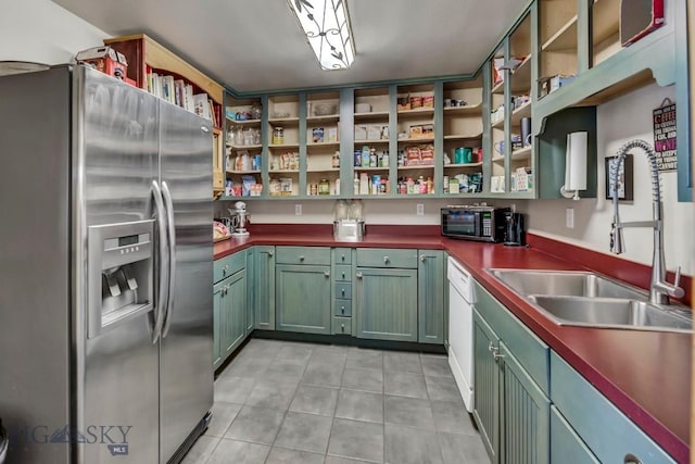 kitchen with open shelves, light tile patterned flooring, stainless steel fridge with ice dispenser, a sink, and dark countertops