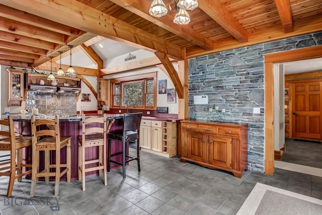 bar featuring pendant lighting, lofted ceiling with beams, range hood, bar area, and wood ceiling