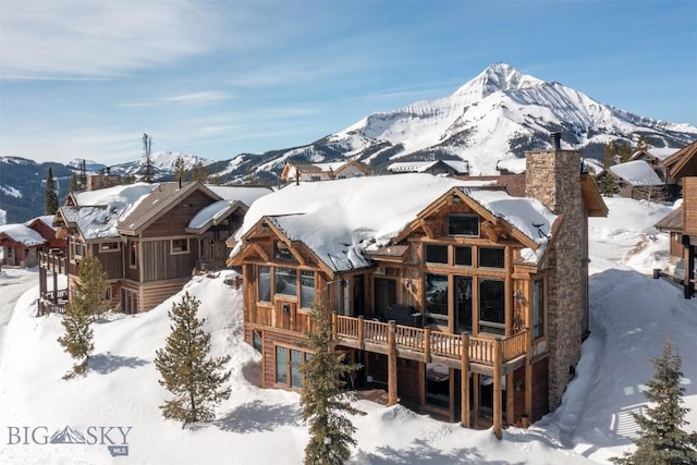 exterior space featuring a mountain view and a chimney