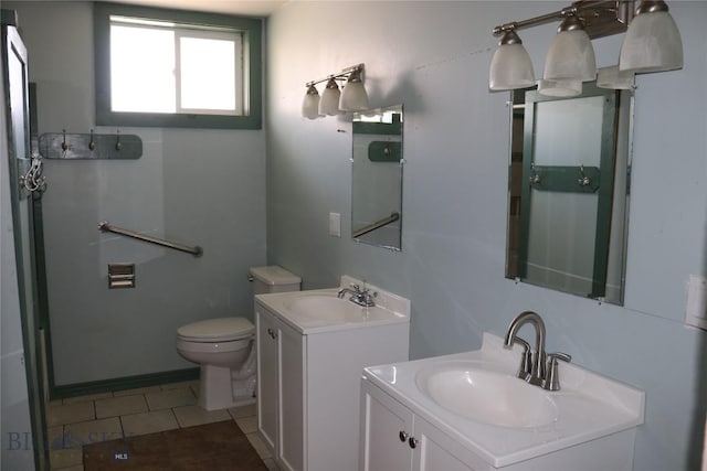 bathroom with two vanities, tile patterned floors, toilet, and a sink