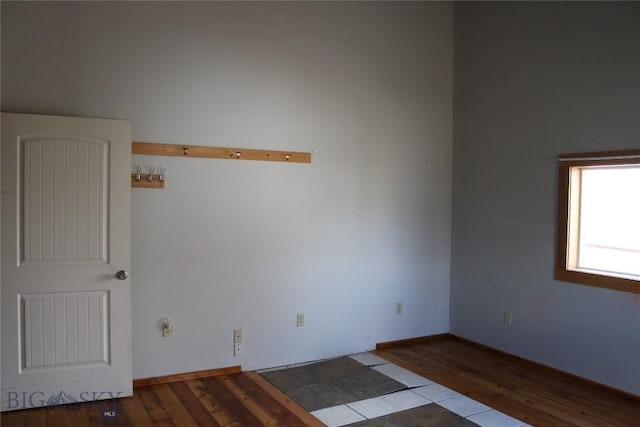 empty room with wood finished floors and baseboards