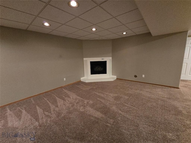 3004 Green Cir, Butte, MT 59701 - unfurnished living room with carpet, recessed lighting, baseboards, a fireplace with raised hearth, and a drop ceiling