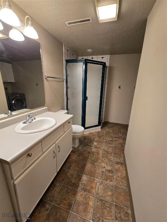 3004 Green Cir, Butte, MT 59701 - bathroom featuring a textured ceiling, vanity, a stall shower, and toilet