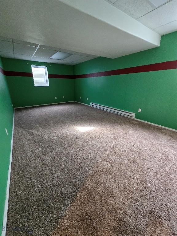 3004 Green Cir, Butte, MT 59701 - basement featuring a baseboard heating unit, carpet floors, a paneled ceiling, and baseboards