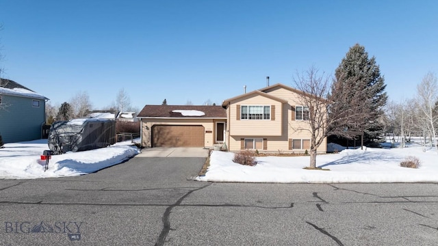 split level home with driveway and a garage