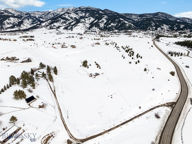 snowy aerial view with a mountain view